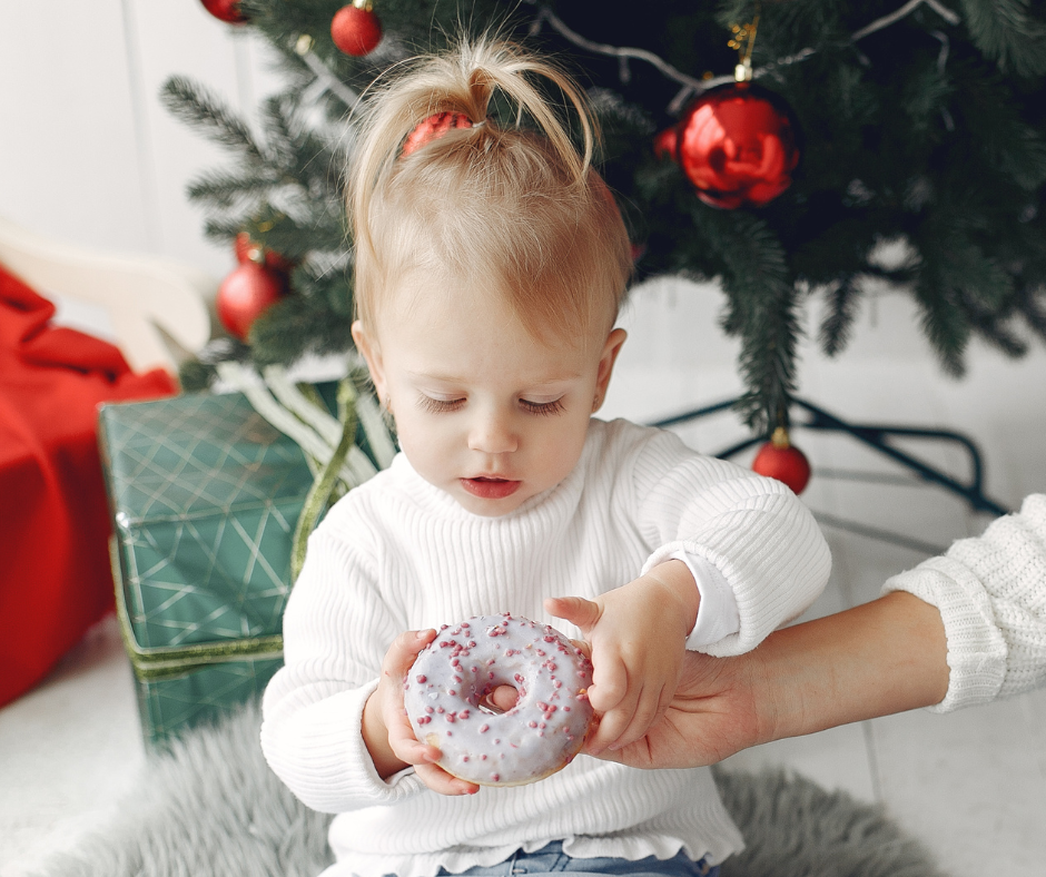 Little girl holding a donut