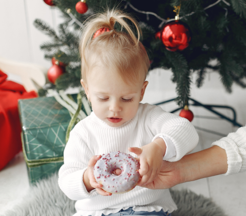 little girl holding donut
