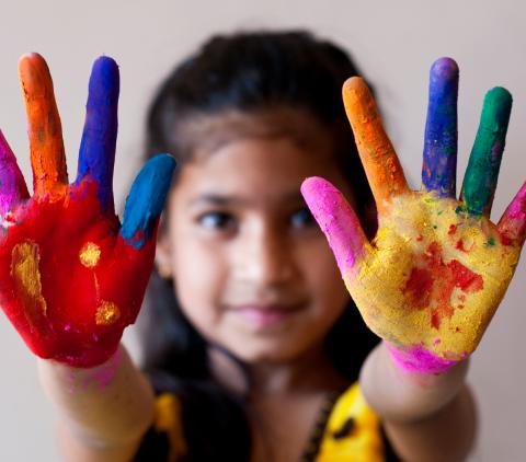 Little girl with paint on her hands