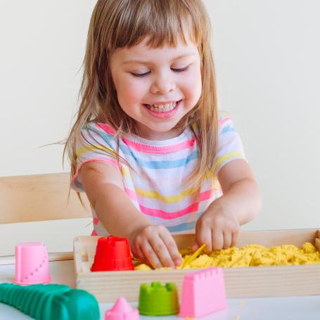 Little Girl playing with play doh