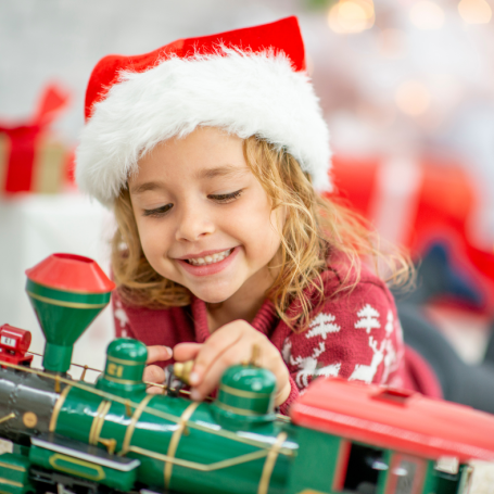 Child playing with a toy train