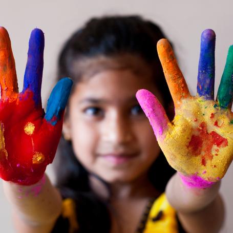 Little girl with paint on her hands