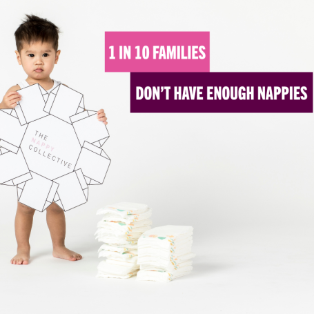 Baby with unused stack of nappies