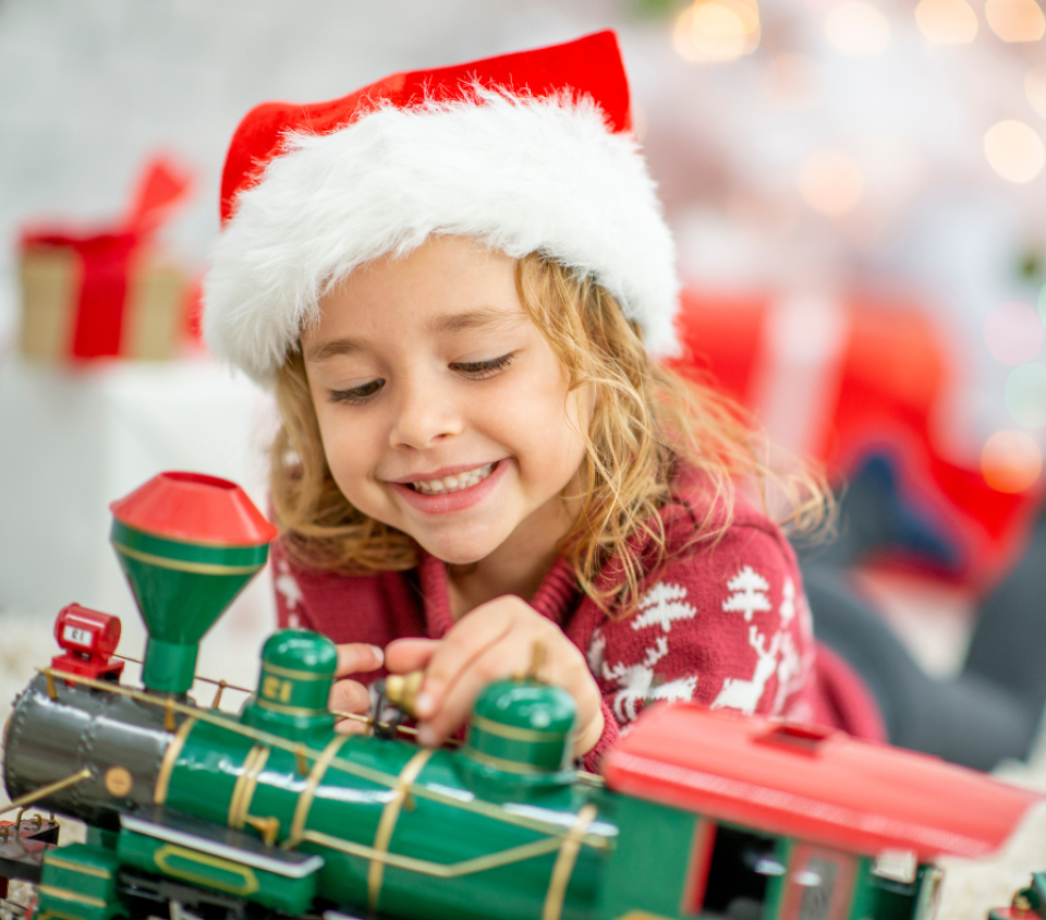 Child playing with a toy train