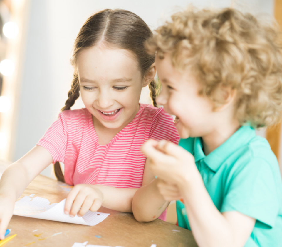 Two kids laughing at each other